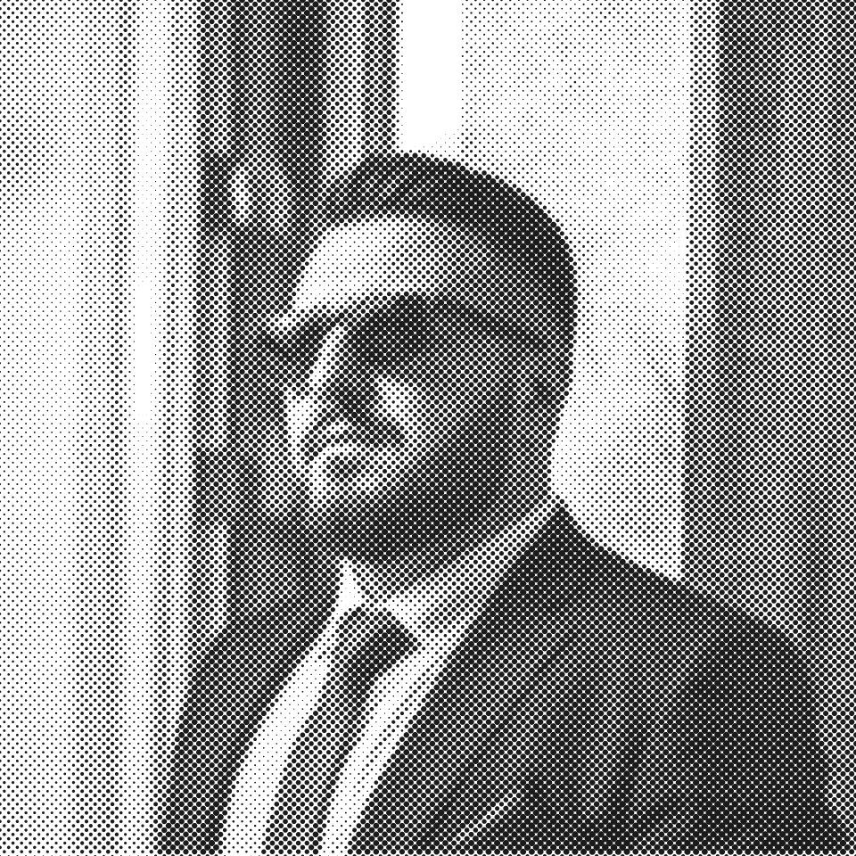 Halftone portrait of Ömer Yanbaş in a dark suit and sunglasses, standing beside a window.
